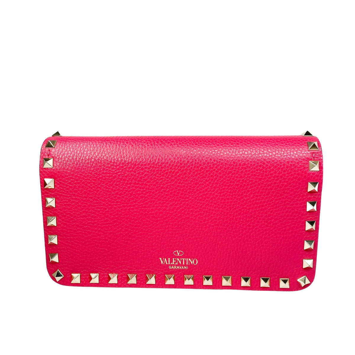 Back view of the hot pink Valentino Rockstud leather clutch showing smooth leather finish and gold logo stamp.