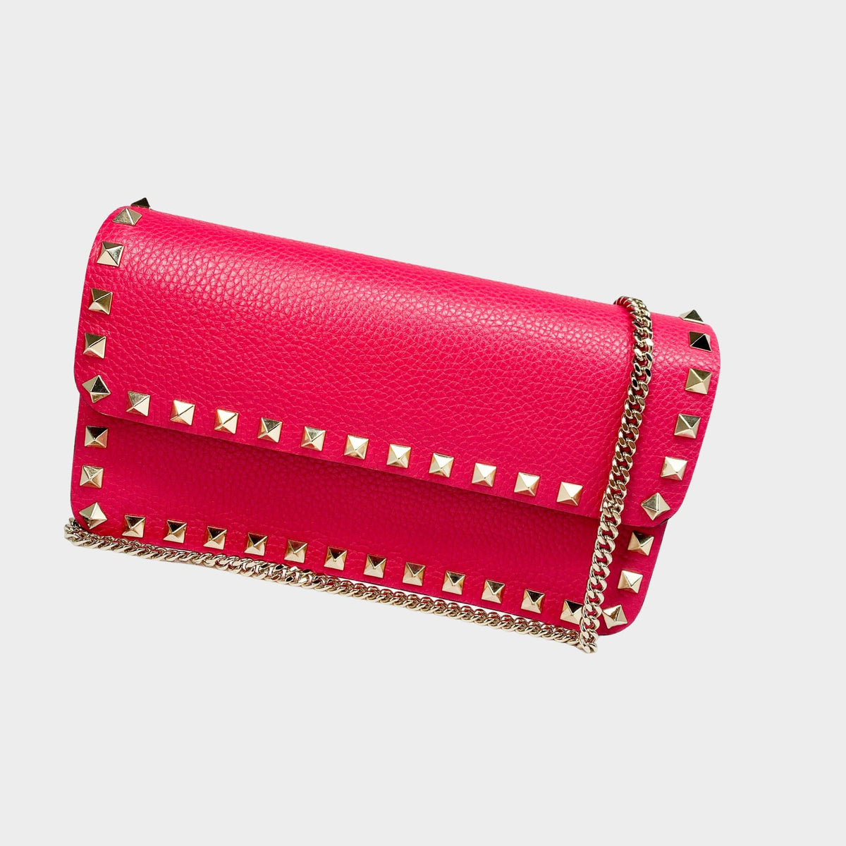 Valentino Rockstud clutch bag in hot pink leather with gold chain strap and platinum pyramid stud trim.