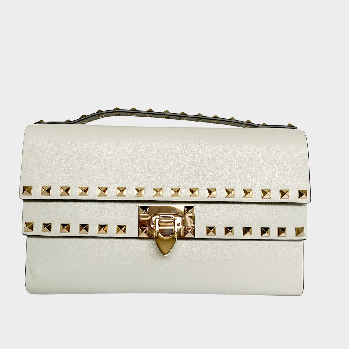 Valentino Rockstud clutch bag in cream white leather featuring gold pyramid studs and top handle.