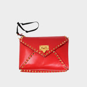Valentino red leather shoulder bag with gold Rockstud trim along the envelope flap closure.