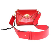 Red Valentino Rockstud shoulder bag displayed open with wide shoulder strap showcasing interior storage space.