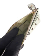 Interior view of the white Valentino Rockstud coin wallet, demonstrating the expansion of the zipped compartment.