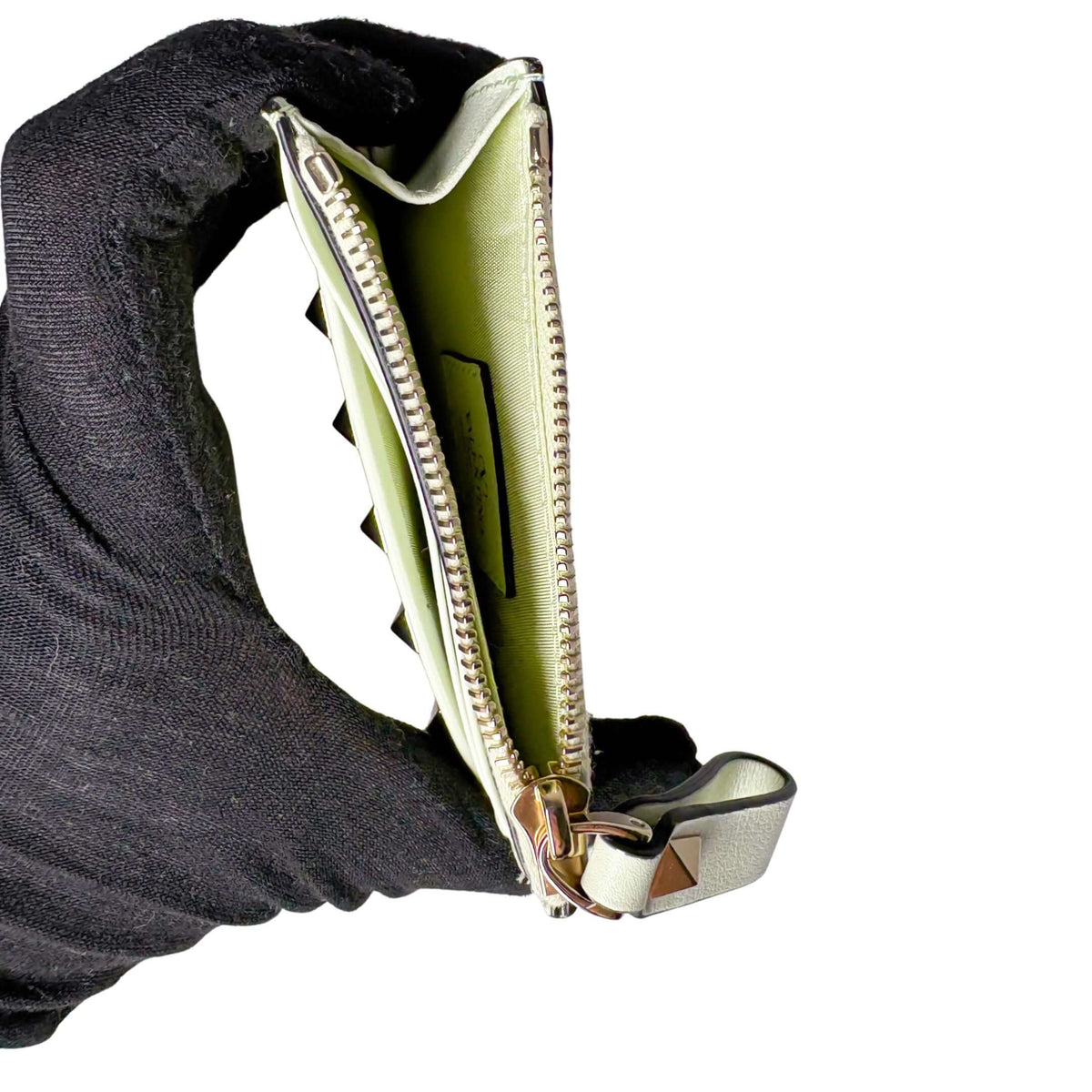 Side profile angle of the white Valentino leather card pouch, showcasing the flexible side gusset and interior lining.