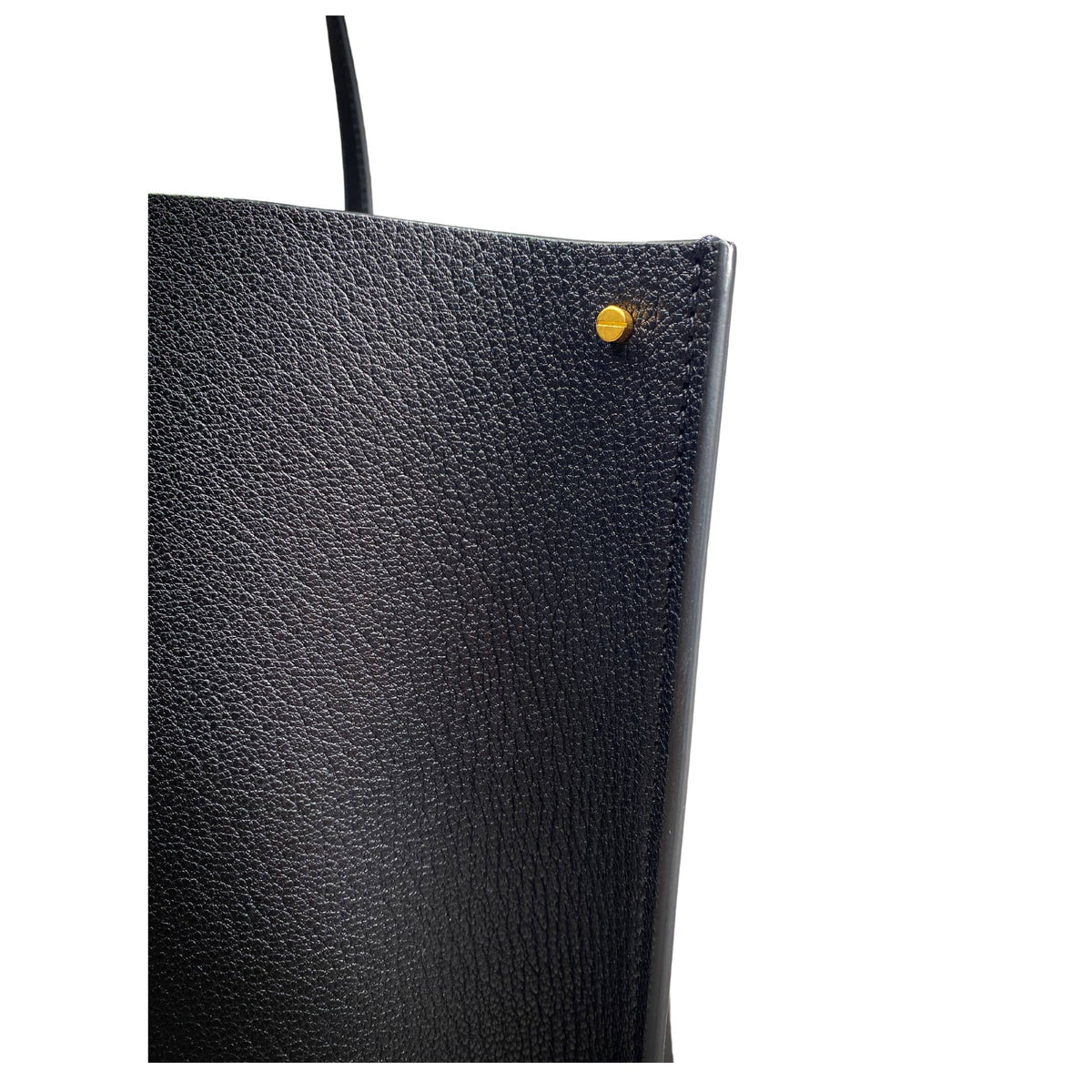 Side profile view of the black Valentino V Tote Bag showing the sleek structured leather construction and edge finishing.