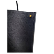 Side profile view of the black Valentino V Tote Bag showing the sleek structured leather construction and edge finishing.