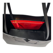Interior view of the Valentino black leather V Tote Bag showing spacious open storage and removable red zipper pouch.