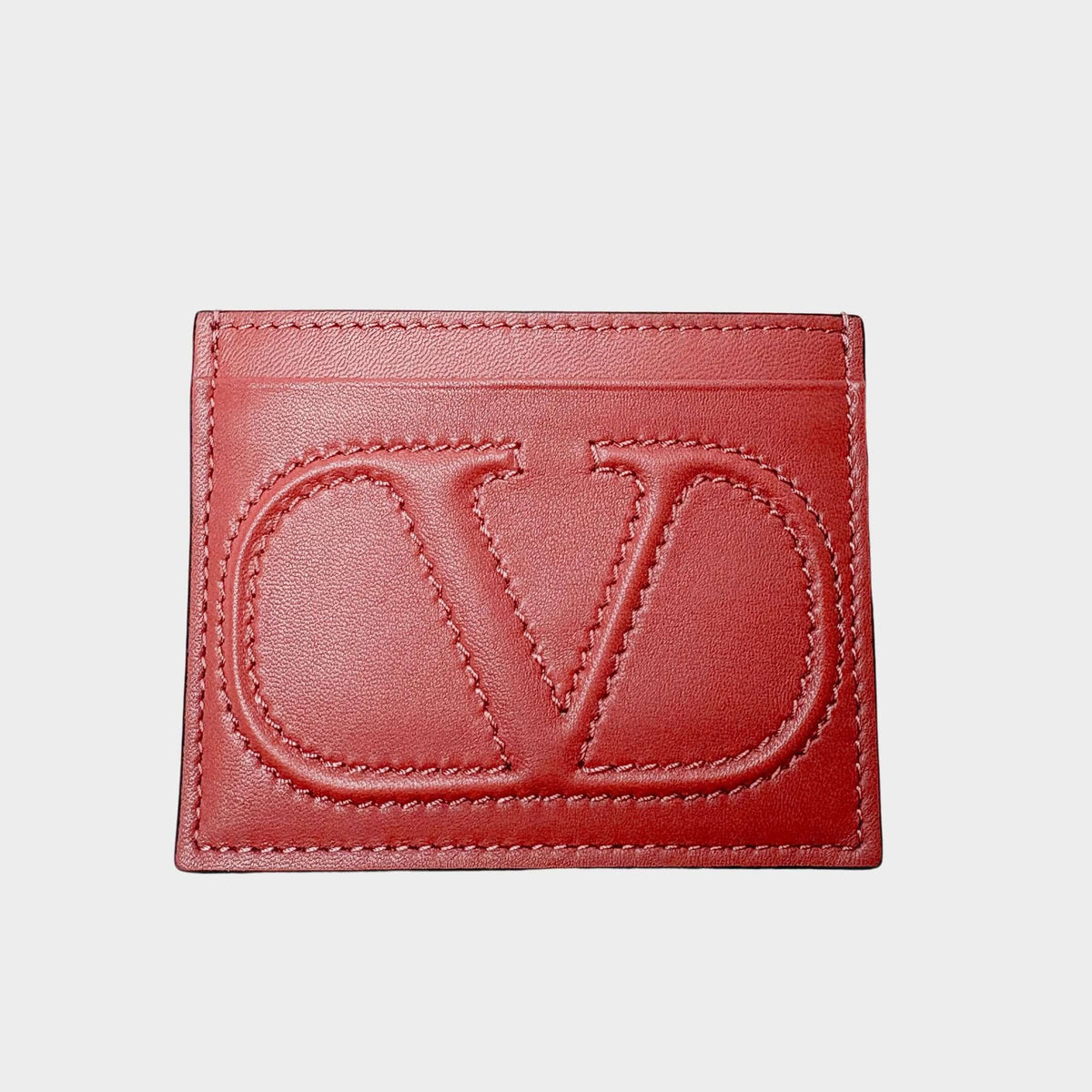 Front view of the Valentino V-Logo card holder in classic red premium leather, showcasing the embossed signature V-Logo.