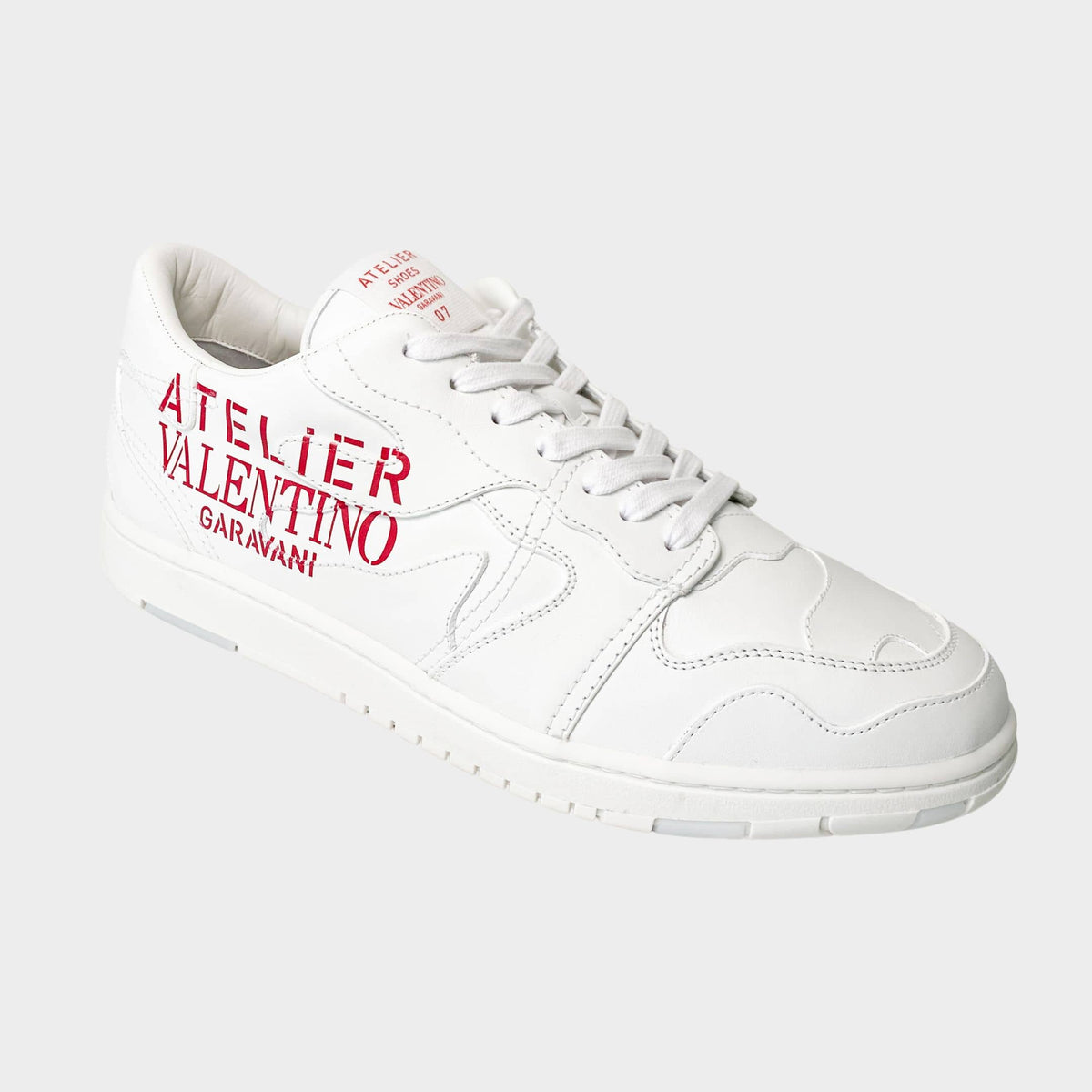 Valentino Garavani Atelier Mens Trainers in white leather featuring red logo text.