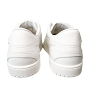 Back view of white Valentino leather sneakers showing structured heel counters and thick rubber soles.