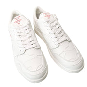 Three-quarter top view of white Valentino Garavani men's low-top leather sneakers.