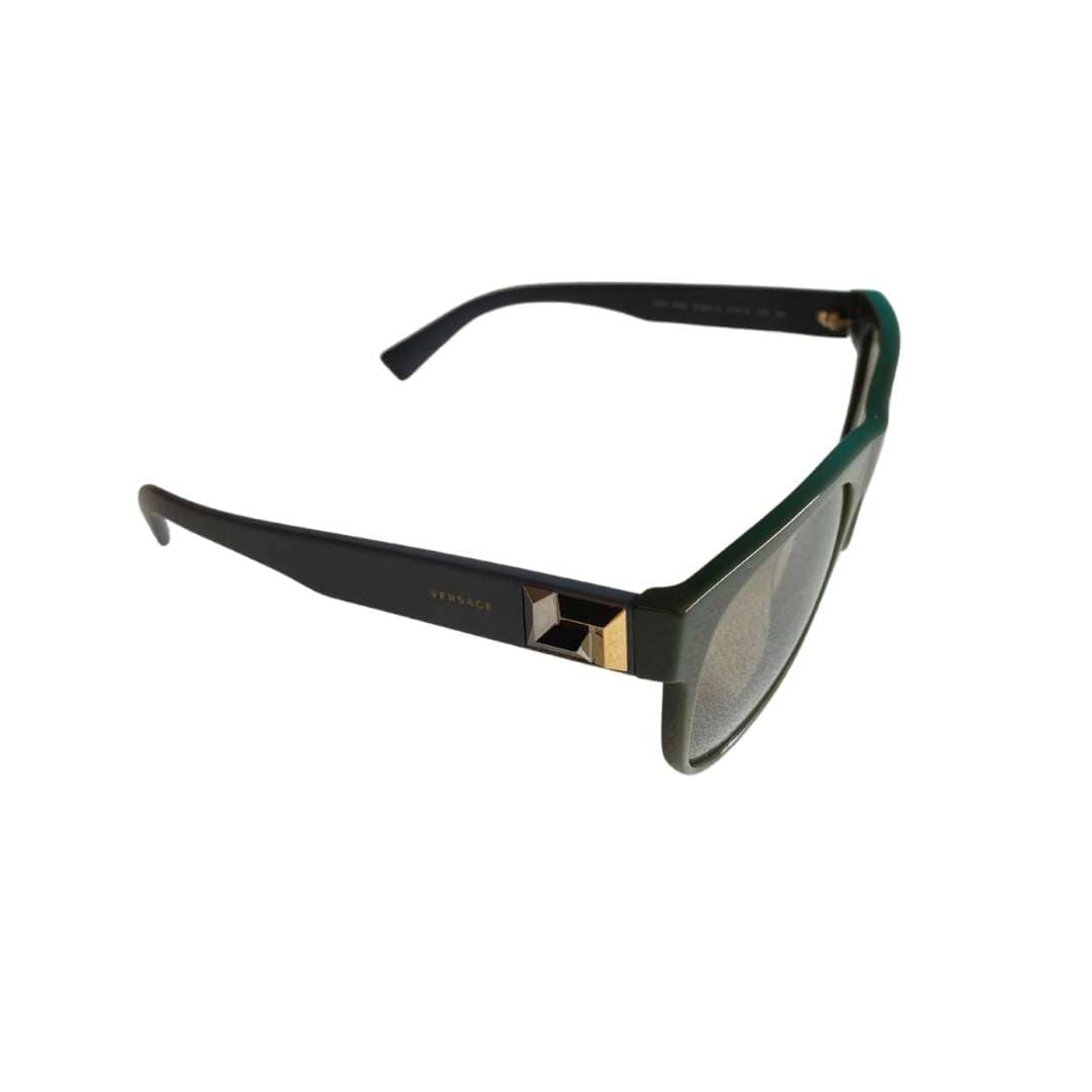 Side profile view of the gray Versace sunglasses, showcasing the iconic gold-tone Medusa emblem detailing on the temple.