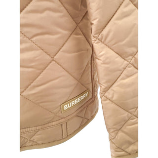 Close-up detail of Burberry Dalry camel quilted jacket showing stitching and texture