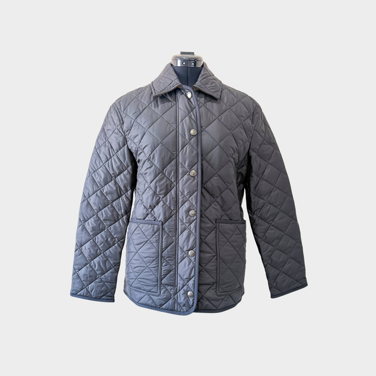 Front view of the classic black Burberry Dalry quilted jacket showcasing its signature diamond-quilted design.