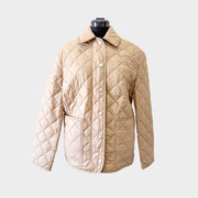 Front view of the luxury Burberry Dalry quilted jacket in a classic camel colorway, showcased on a display mannequin.