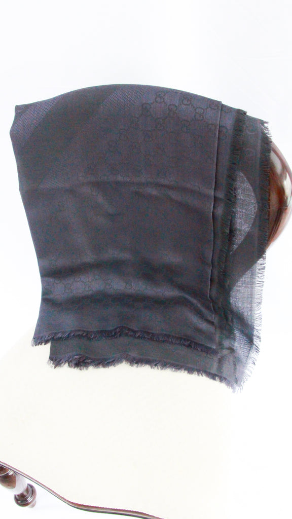 Gucci GG Monogram Jacquard Silk Wool Scarf in navy blue square silhouette with fringe trim.