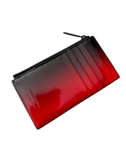 Close-up view of Ferragamo ombre leather zip card case displaying exterior card slots and stitching.