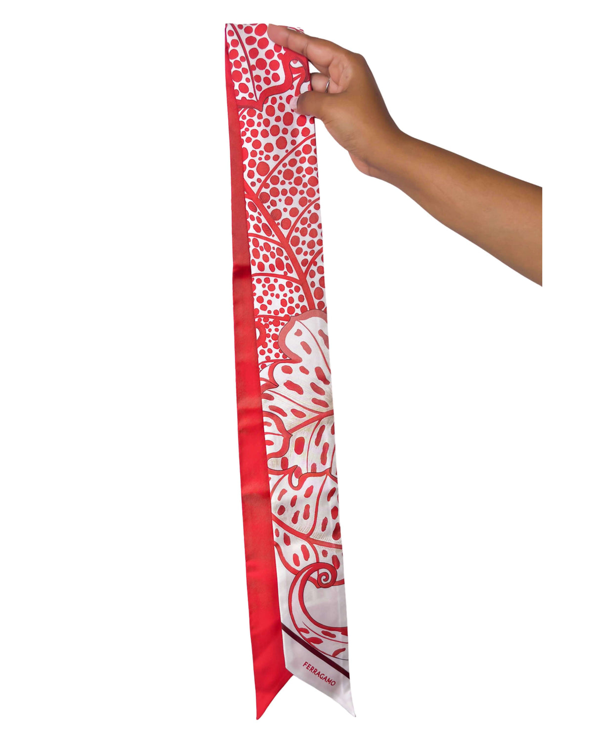 Full length vertical view of the red Salvatore Ferragamo foliage print silk scarf showing the tapered angled ends.