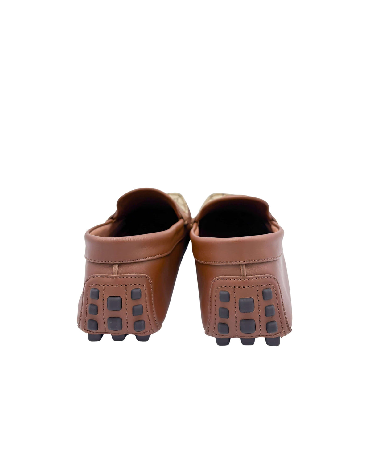 Back view of Gucci driver moccasins showcasing brown leather heel counters and driver rubber sole wrap.