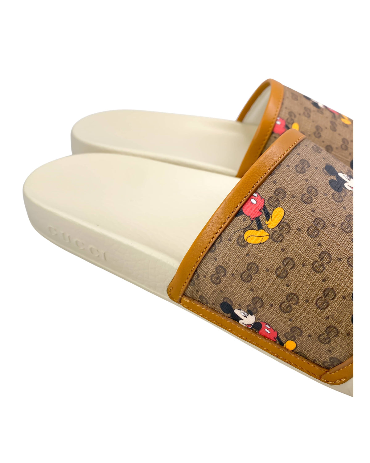 Close-up of Gucci x Mickey Mouse slides showing Mickey Mouse graphic and logo