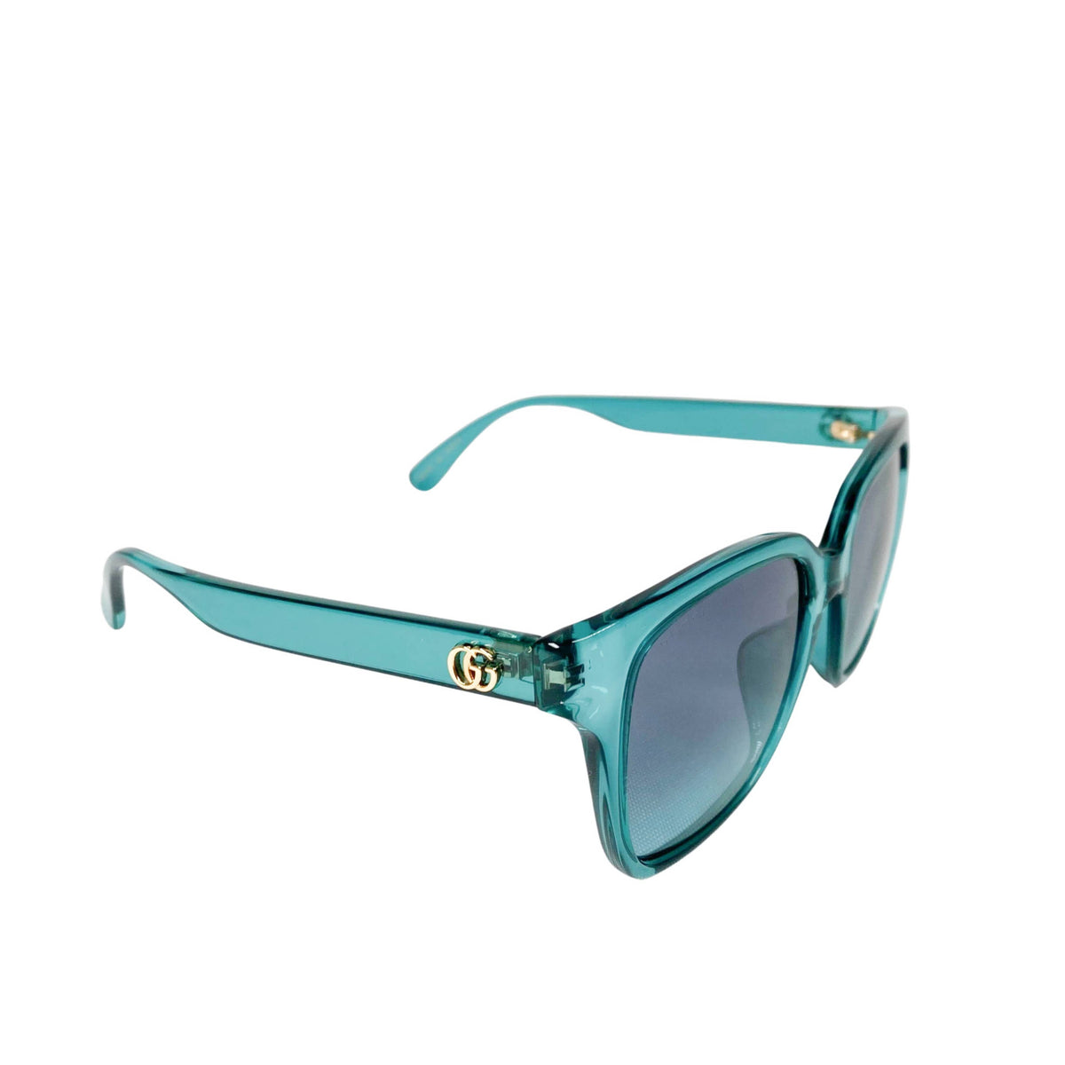 Three-quarter side angle of the turquoise Gucci sunglasses, showcasing the temple arm design and frame structure.