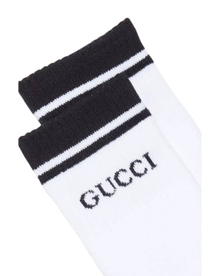Close-up of Gucci white striped tennis socks showing logo and stripe detail