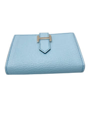 Side profile view of Hermès Bearn Small Wallet in Blue Zephyr highlighting the iconic silver H clasp detail and leather grain.