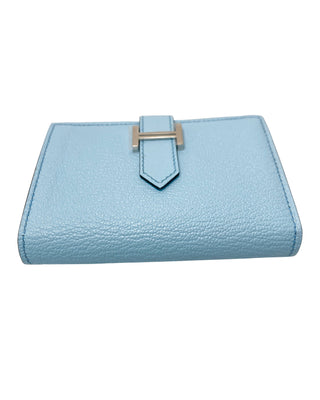 Side of Hermès Bearn small wallet in blue zephyr showing H tab closure detail