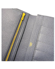 Close-up detail view of the interior zip pocket and metallic zipper pull inside the Hermès Bearn Soufflet wallet in Blue Indigo.