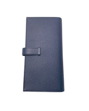 Rear view of Hermès Bearn Soufflet wallet in Blue Indigo displaying fine leather grain, precise edge stitching, and clean minimalist silhouette.