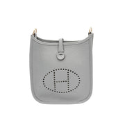 Front view of Hermès Evelyne Amazone 16 handbag in Gris Patin grey displaying the classic perforated H design and compact silhouette.