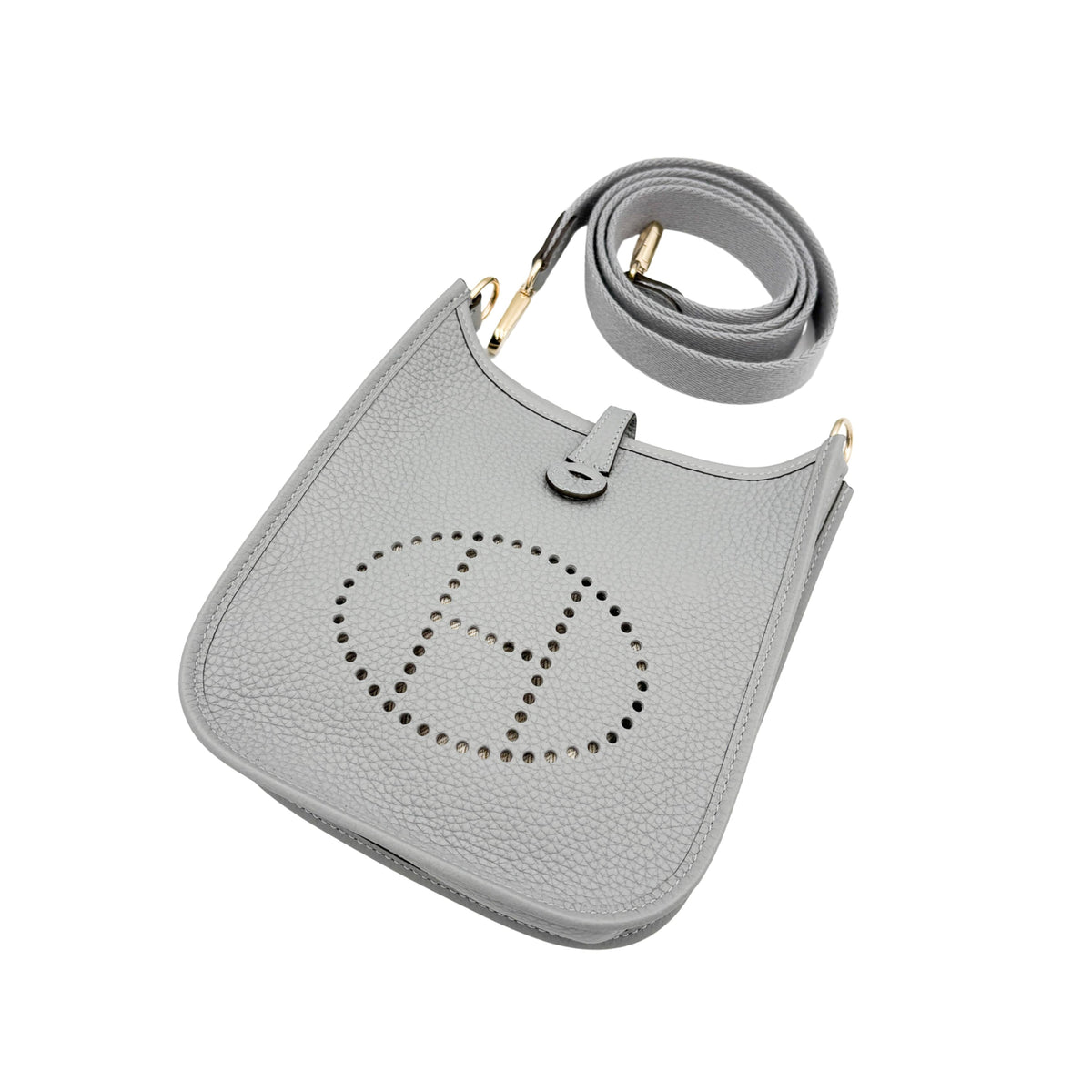 Angled top view of Hermès Evelyne Amazone 16 in Gris Patin highlighting the perforated H emblem, soft leather grain, and shoulder strap ring attachment.