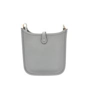 Rear view of Hermès Evelyne Amazone 16 in Gris Patin grey leather showing clean back panel, snap closure tab, and precise perimeter stitching.