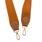 Detailed shot of Gold Taurillon Clemence leather side trim and reinforced stitching on the Hermès Evelyne III 29 canvas bag.