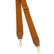 View of the canvas and Gold leather adjustable shoulder strap designed for crossbody or shoulder wear on the Hermès Evelyne III bag.