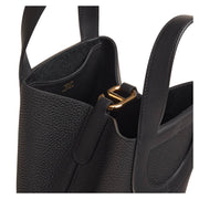 Close-up detail view of the gold-tone hardware and iconic Chaîne d'Ancre motif handle attachment on the black Hermès In-the-Loop 18 bag.