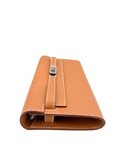 Side profile view of Hermès Kelly-To-Go wallet in Gold Epsom leather highlighting its slim structure and flap closure.