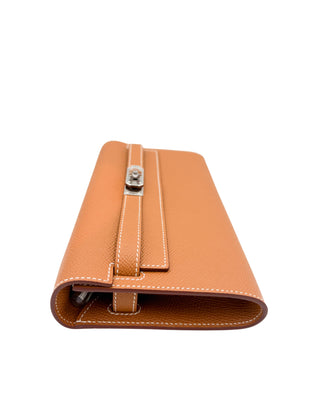 Side profile of Hermès Kelly-To-Go wallet in Gold Epsom leather highlighting slim structure and detachable strap