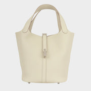 Front view of Hermès Picotin Lock 22 bucket bag in light grey Beton Clemence leather with dual top handles and palladium hardware.
