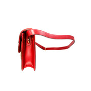 Side profile view of the Gucci GG Ring red suede shoulder bag, demonstrating its sleek depth and clean craftsmanship