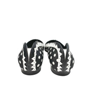 Rear view of the Manolo Blahnik Elaphiria black and white patterned flats highlighting the minimalist flat heel design.