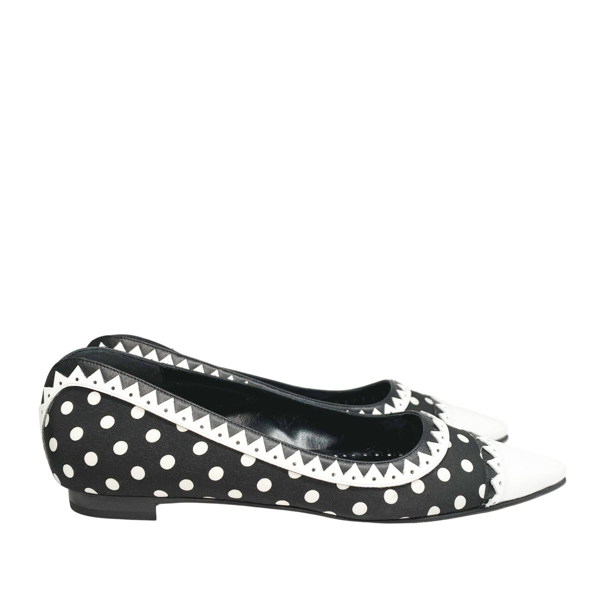 Side profile view of a single Manolo Blahnik Elaphiria flat highlighting the low silhouette and white leather trim.