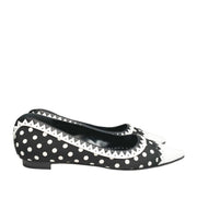Side profile view of a single Manolo Blahnik Elaphiria flat highlighting the low silhouette and white leather trim.