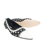 Angled view of a pair of Manolo Blahnik Elaphiria flats showing the beige leather insoles and contrasting white pointed toes.