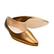 Side profile view of a gold leather Manolo Blahnik BB flat showcasing the low minimalist heel and clean silhouette.