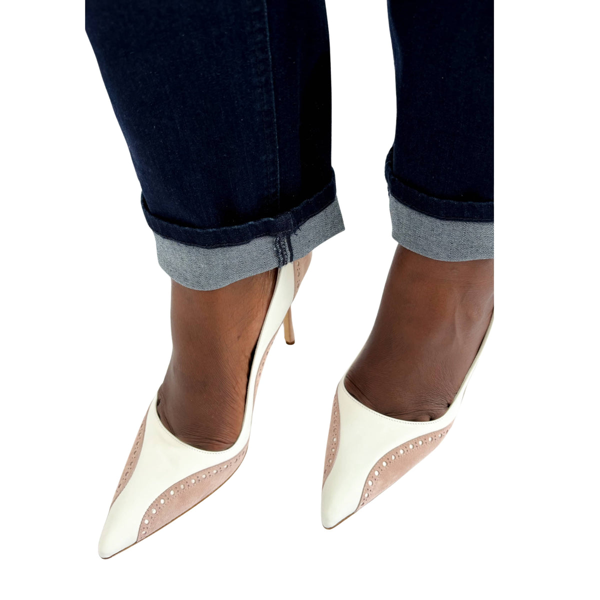 Close-up view of a person wearing Manolo Blahnik Minisia white satin heels with cropped denim jeans.