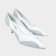 Three-quarter studio view of Manolo Blahnik Minisia 70 white leather pointed-toe pumps featuring light blue lace-trimmed overlays and mid heel.