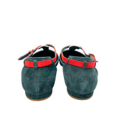 Rear view of a pair of Manolo Blahnik Vree green suede flats detailing the pink heel straps and flat heel profile.