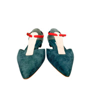 Front view of a pair of Manolo Blahnik Vree green suede flats highlighting the elegant pointed-toe design and pink strap accents.