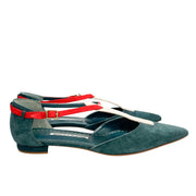 Side profile view of Manolo Blahnik Vree green suede flat shoe showing the sleek silhouette and pink strap construction.
