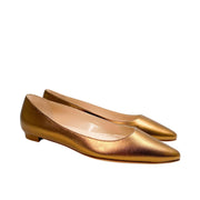 Side-angle view of a pair of Manolo Blahnik BB flats in radiant gold leather.